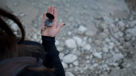 woman holding compass while hiking
