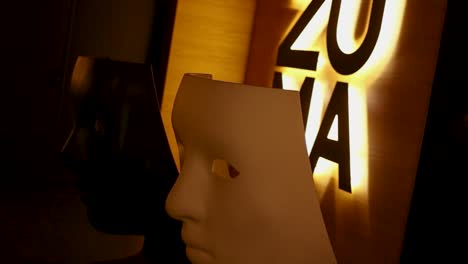 masks and illuminated sign in a restaurant