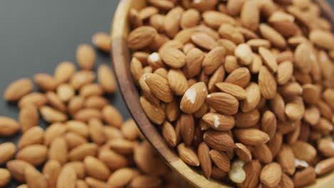 Video-of-fresh-fruit-almonds-in-a-bowl-on-grey-background