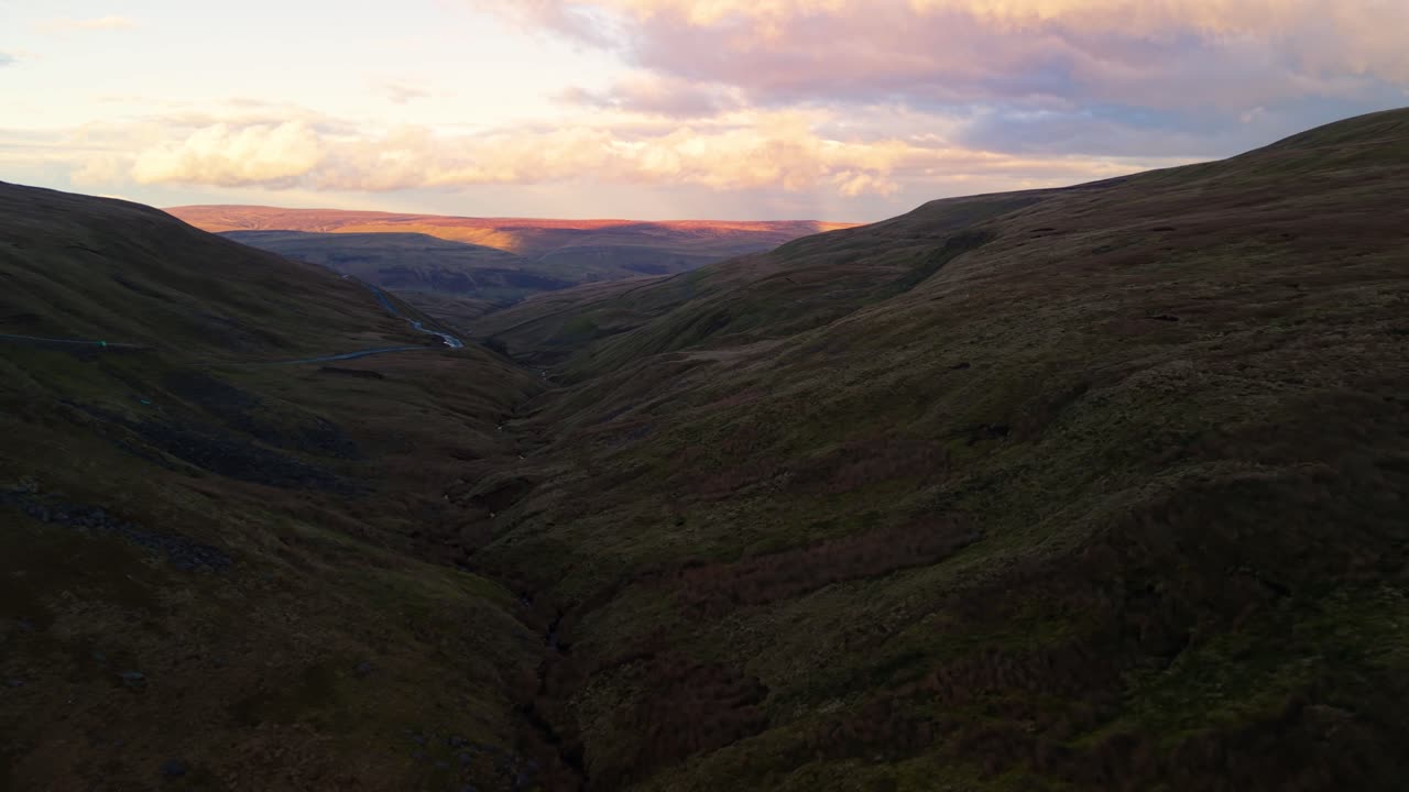 Scenic Buttertubs Pass views in Yorkshire Dales' serene sunset light