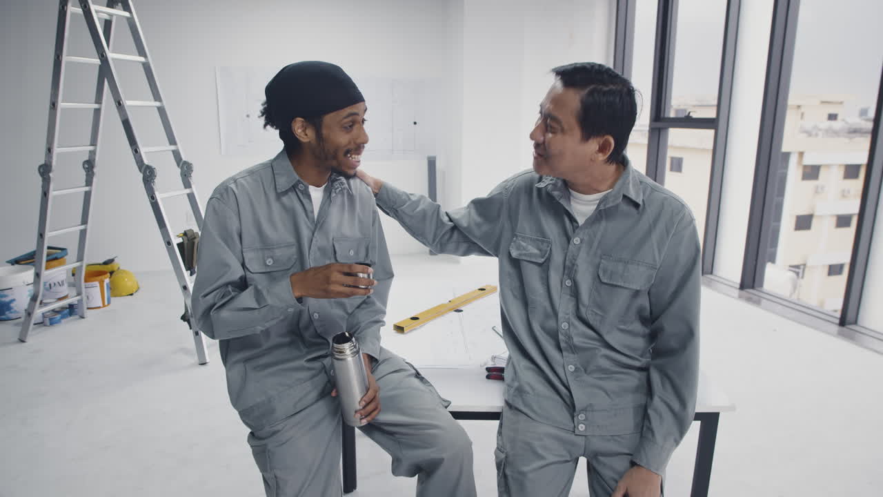 Diverse Coworkers Having Break with Tea at Construction Site