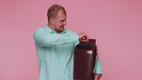 Smiling-man-taking-off,-throwing-out-glasses-into-bin-after-vision-laser-treatment-therapy