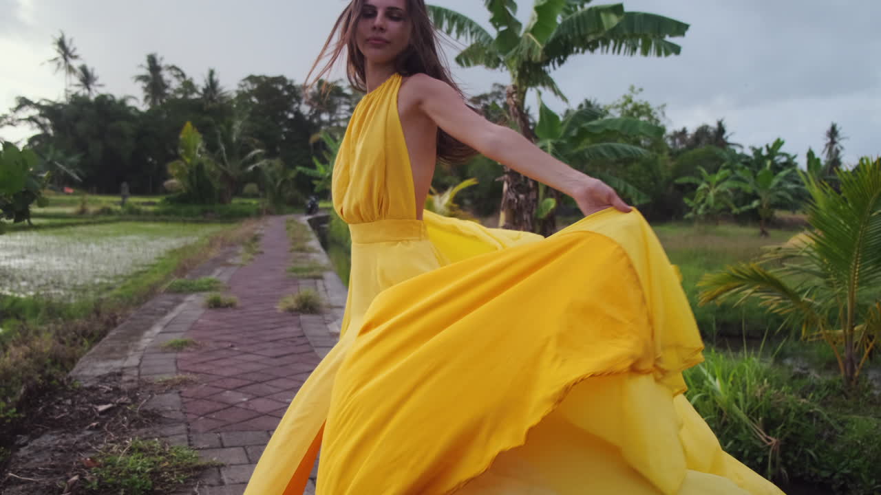 Woman in Yellow Dress in Tropical Setting