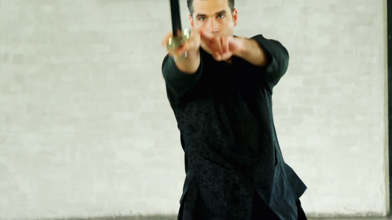 Kung fu fighter practicing martial arts with sword 4k