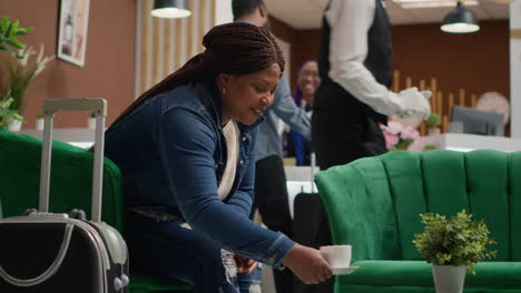 bellhop serving cup of coffee for woman