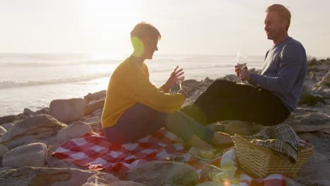 couple drinking wine by the sea