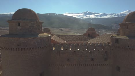 drone shot around the towers of the castle of la calahorra in granada, spain