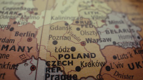 Close-up of a world map, highlighting Poland and surrounding countries
