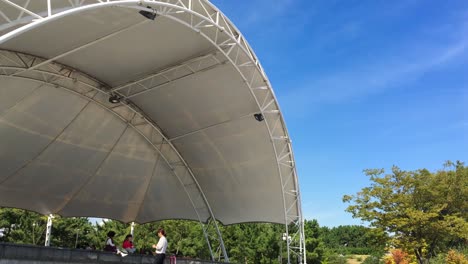 outdoor stage with tensile canopy and people