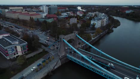 Aerial-view-of-car-traffic-flowing-towards-the-Grunwald-Bridge-over-the-Oder-River-in-the-city-of-Wrocław,-Poland