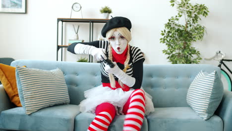 mime playing video games on a couch