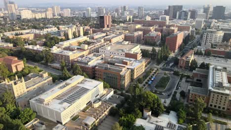 UCLA-Mathematical,-Sciences-building,-aerial-over-campus-building,-Westwood-in-the-distance,-Los-Angeles