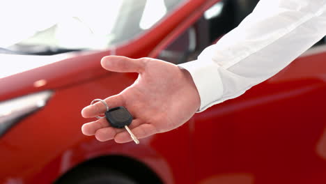 Businessman-holding-out-car-keys