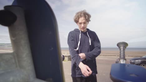 young adult male walks up to exercise equipment and does push ups on it