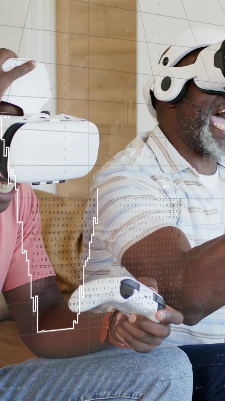 Vertical video: Senior urging adult to wear white VR headsets, both using remotes for gaming HUD