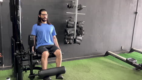 latin man with beard and long hair in extension chair equipment