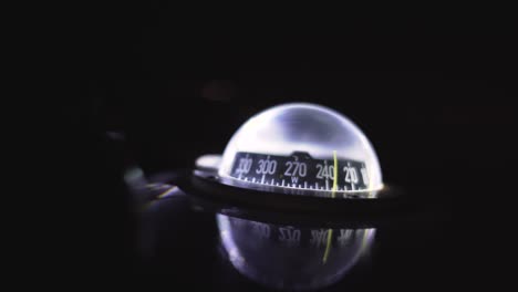 marine compass on a sailing yacht at night. backlit compass