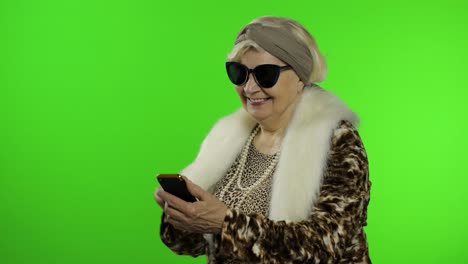 Elderly-caucasian-grandmother-woman-using-smartphone-for-shopping.-Chroma-key