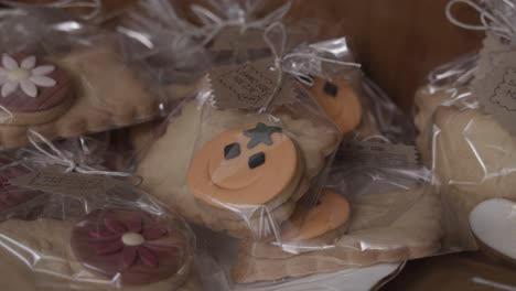 halloween butter cookies lie on a wooden plate in an artisan patisserie display