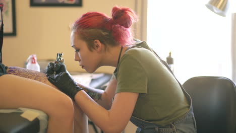 tattoo artist working on a knees tattoo