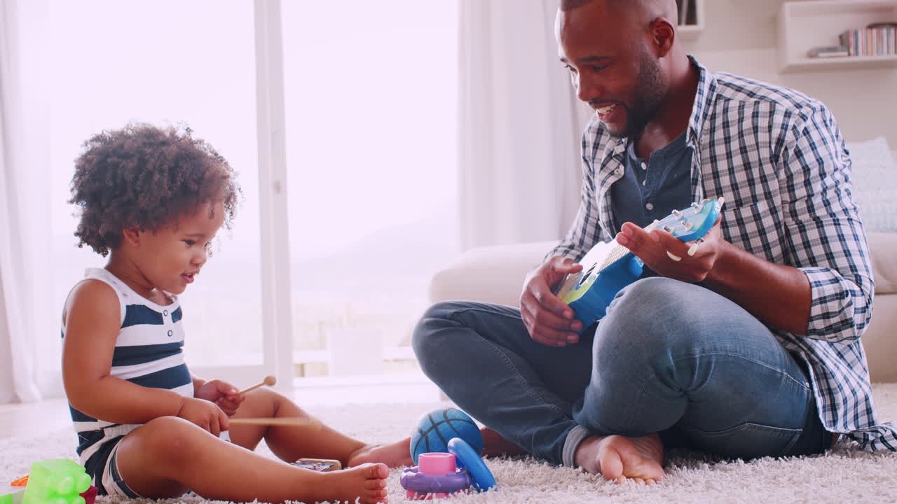 Young black dad and his young daughter playing instruments