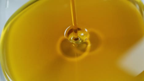 pouring oil car motor or olive vegetable cooking and bubble isolated. pouring honey. slow motion