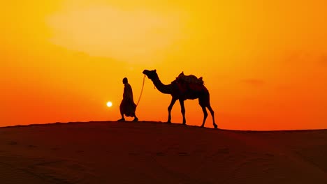 Cameleers,-camel-Drivers-at-sunset.-Thar-desert-on-sunset-Jaisalmer,-Rajasthan,-India.