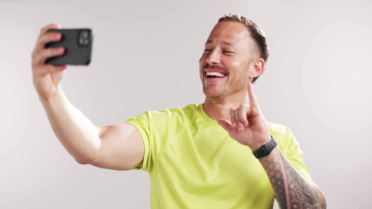 Cheerful Man Taking a Selfie and Showing Number One