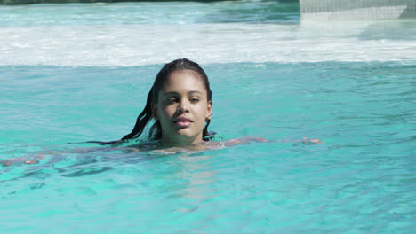 beautiful woman swimming in swimming pool