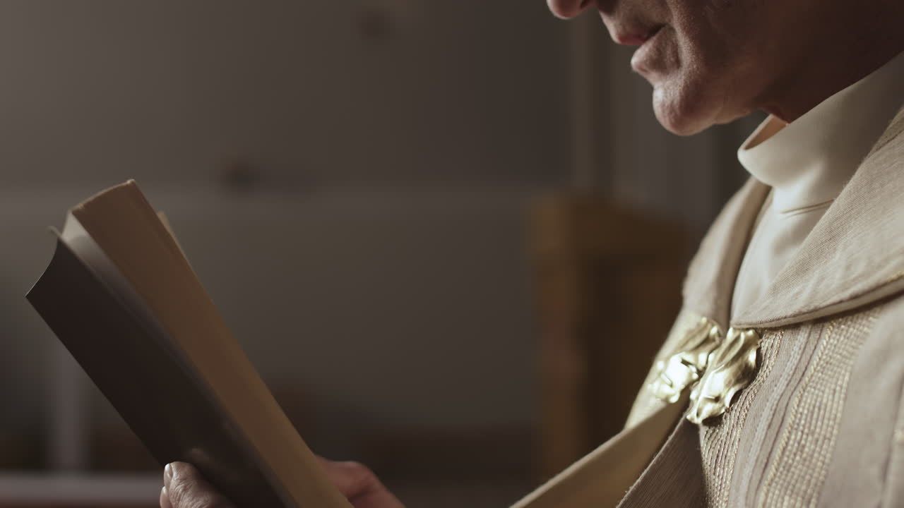 Unrecognizable Old Clergyman Reading Holy Bible