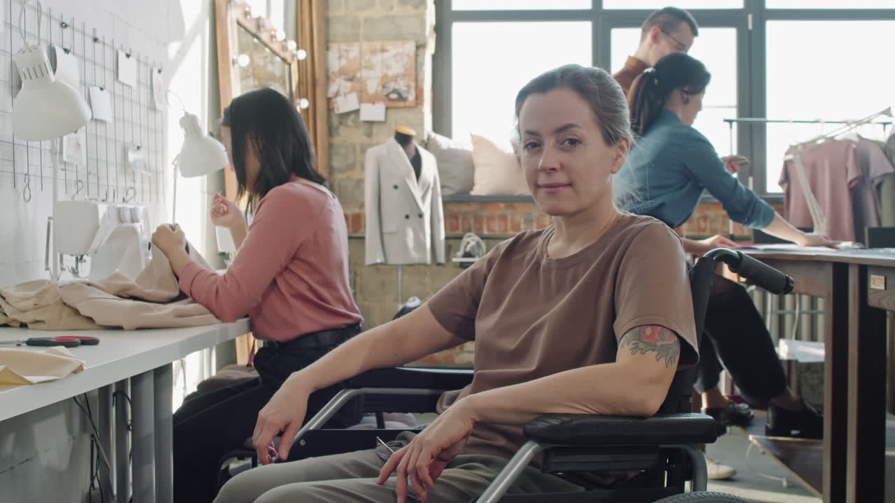 Female Seamstress in Wheelchair Posing in Workplace