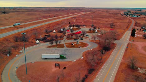 Aerial View of Native American-Themed Rest Area with Teepee Structures Along Colorado Interstate Highway