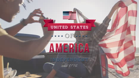 biracial women taking photos holding us flag with independence foreground