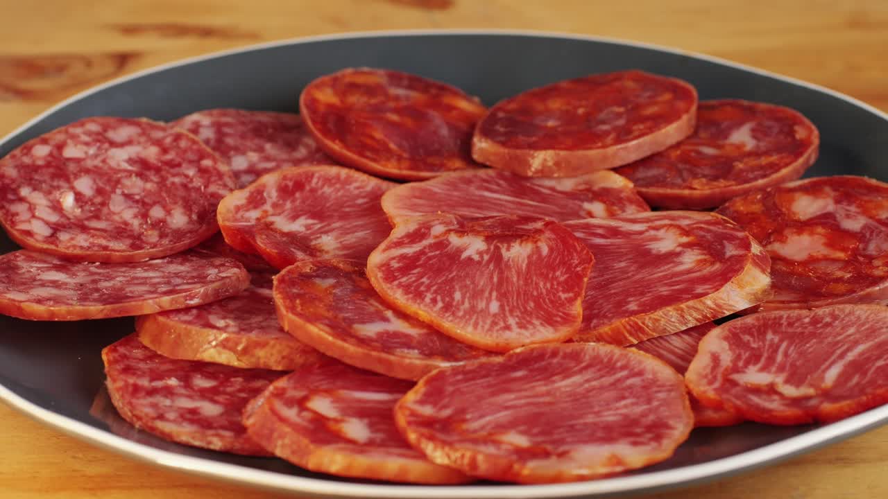Mix of spanish pork sausages, Cutting board of appetizing catalonian snack - fuet, jamon, chorizo, olives, supermarket tapas food in spain, traditional cuisine.