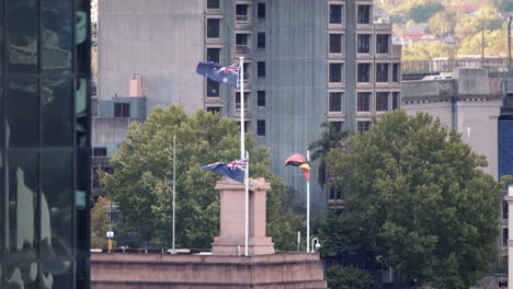 Flagge-Der-Aborigines-Neben-Australischen-Flaggen,-Die-In-Einer-Stadt-Im-Wind-Wehen---Statische-Aufnahme