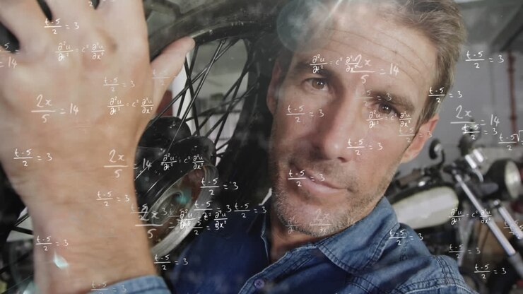 Man carrying a wheel over mathematical equations.