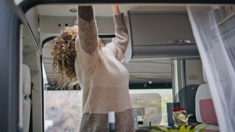 happy woman exploring trailer resting at vacation closeup. lady in campervan