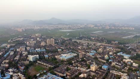 panoramic view on the town of vasai on a misty day near mumbai westen suburbs, india - aerial drone shot
