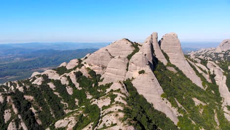 aerial: montserrat mountain range from the air in a sunny day