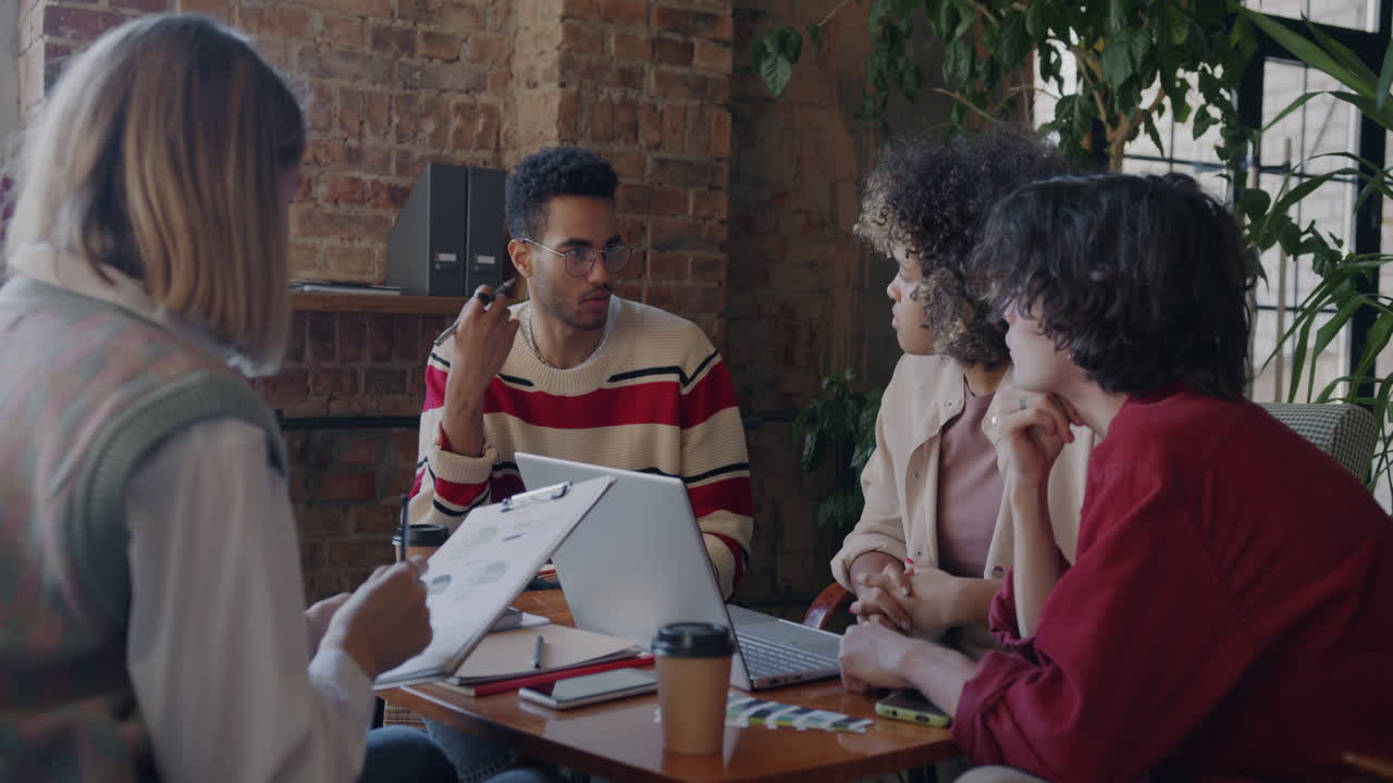 Creative Team Brainstorming Session in a Coffee Shop