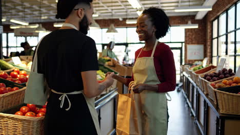 customers and employees interacting in a bustling supermarket produce section