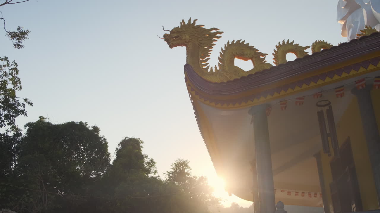 Sunrise over a Buddhist Temple with Dragon Decorations