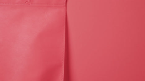 Video-of-red-canvas-bag-with-copy-space-on-red-background