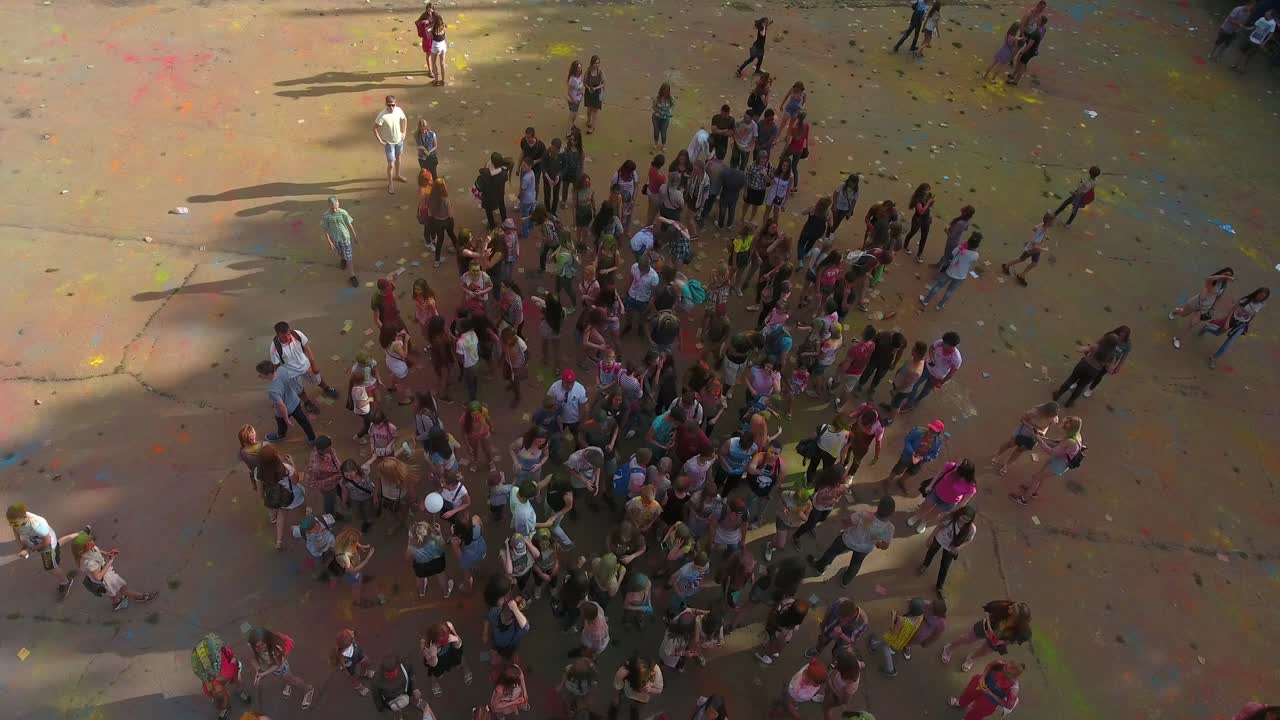 People Celebrating Festival Of Colors. VINNITSA, UKRAINE - JULY 2017: Young people at holi party covered with color powder
