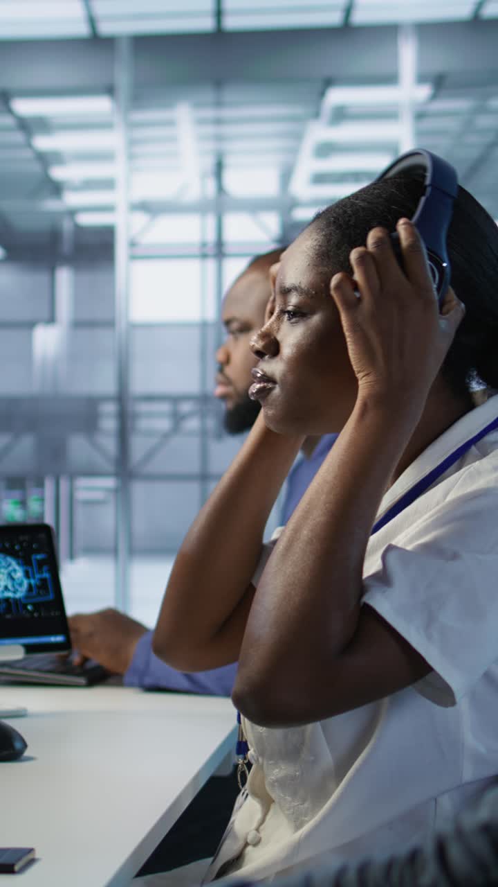 Vertical video Woman in server hub listening music while ensuring optimal system performance