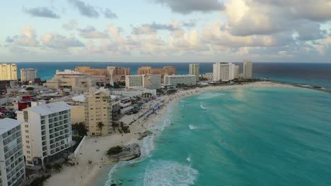aerial reveal: beautiful blue waves crash onto beaches in cancun hotel zone