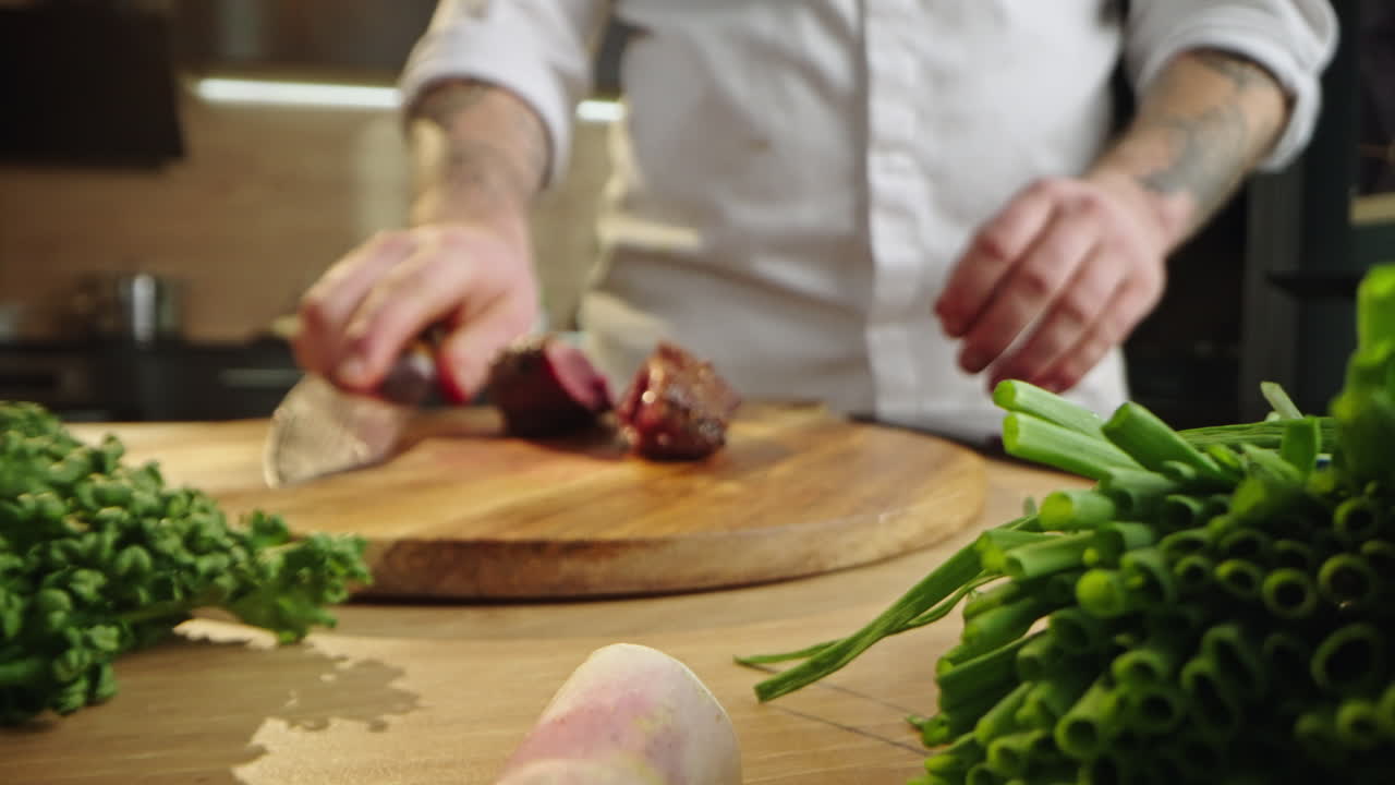 Chef preparing meat and vegetables on a wooden board