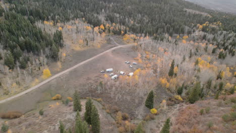 rvs parked on the campground surrounded by green and autumn colors