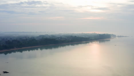 misty haze above ocean coastline with tropical rainforest in thailand