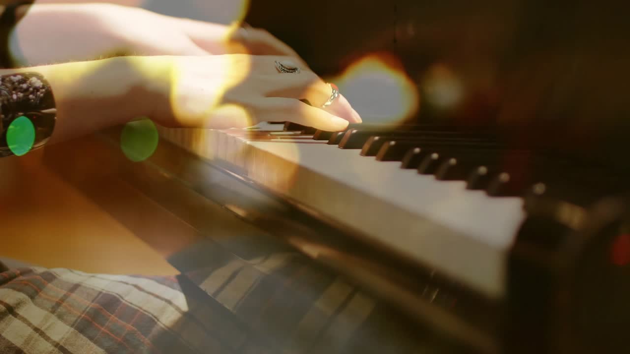 Female pianist entering from left, playing chords across piano keys, creating music, bokeh reacting